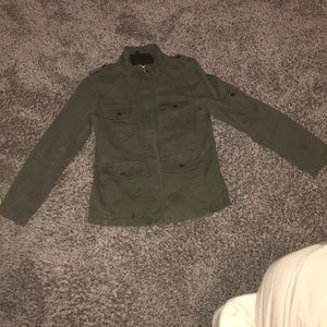 Dark green jacket with gold snaps and zipper.